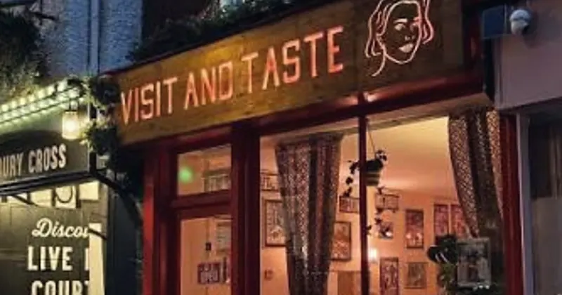 Visit and Taste café front in the evening